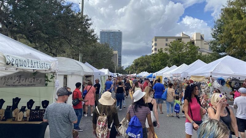Crowds strolling past artist tents at Fall Fiesta in the Park